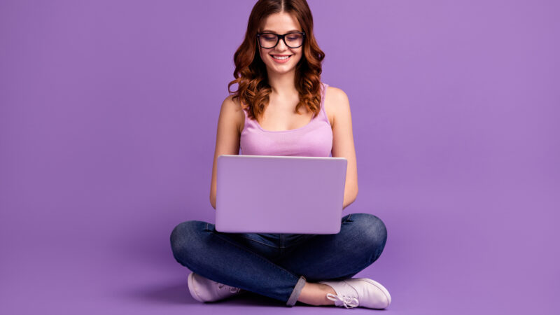 Portrait of charming lovely nice lady have device social networking feel positive, information wear stylish trendy style hipster outfit isolated purple violet background