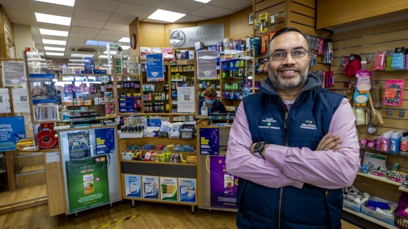 Pharmacist standing in front of the pharmacy counter