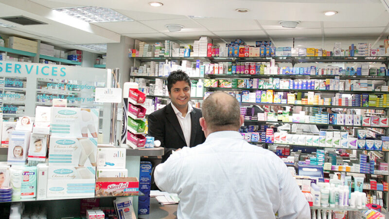 pharmacist helping resident with medicine